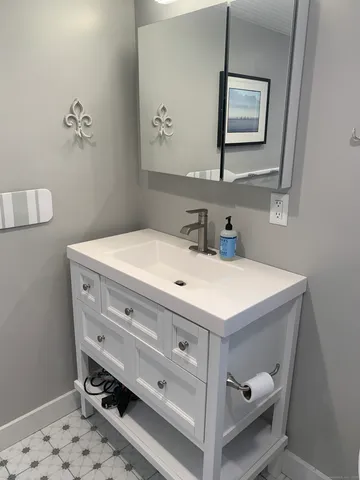 a bathroom with a sink and a mirror