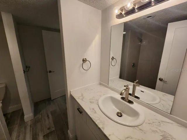 a bathroom with a sink and a mirror