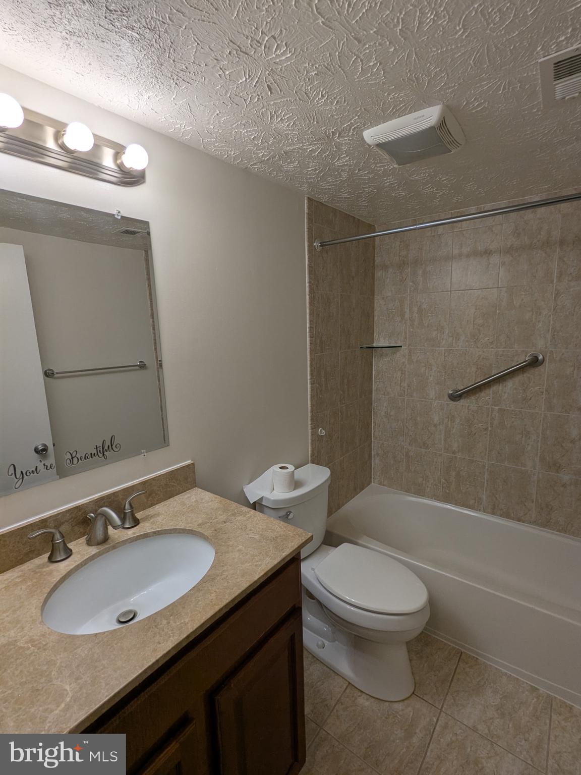 7931 Mandan Road, Unit 623 Greenbelt, MD 20770 - Photo 3 of 6 a bathroom with a sink toilet and shower