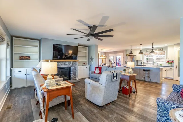 a living room with furniture a flat screen tv and a fireplace