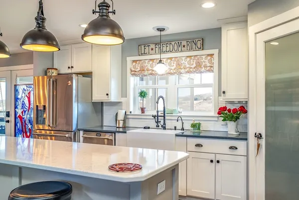 a view of kitchen with stainless steel appliances cabinets and stove