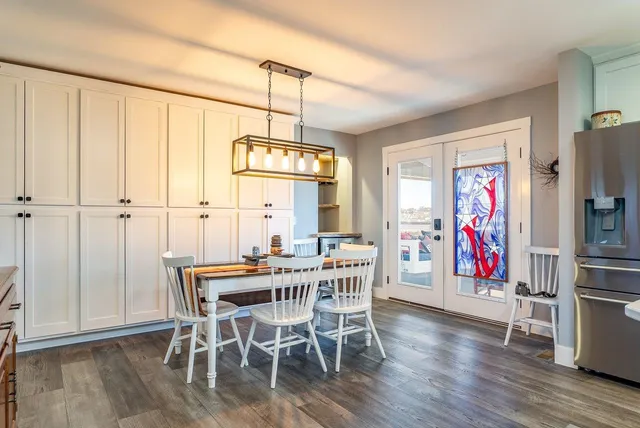 a bathroom with a granite countertop sink toilet a mirror and shower
