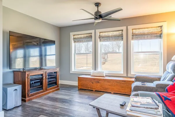 a living room with furniture a ceiling fan and a rug