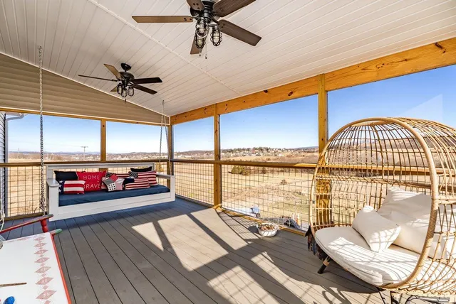 a bedroom with furniture and a floor to ceiling window