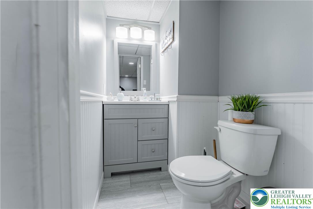 345 South Whitfield Street Nazareth, PA 18064 - Photo 23 of 29 a bathroom with a granite countertop toilet a sink and a mirror