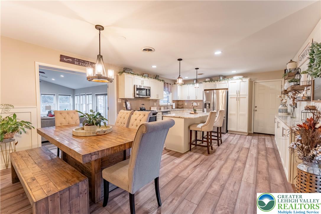 345 South Whitfield Street Nazareth, PA 18064 - Photo 4 of 29 a view of a dining room and livingroom with furniture wooden floor a chandelier