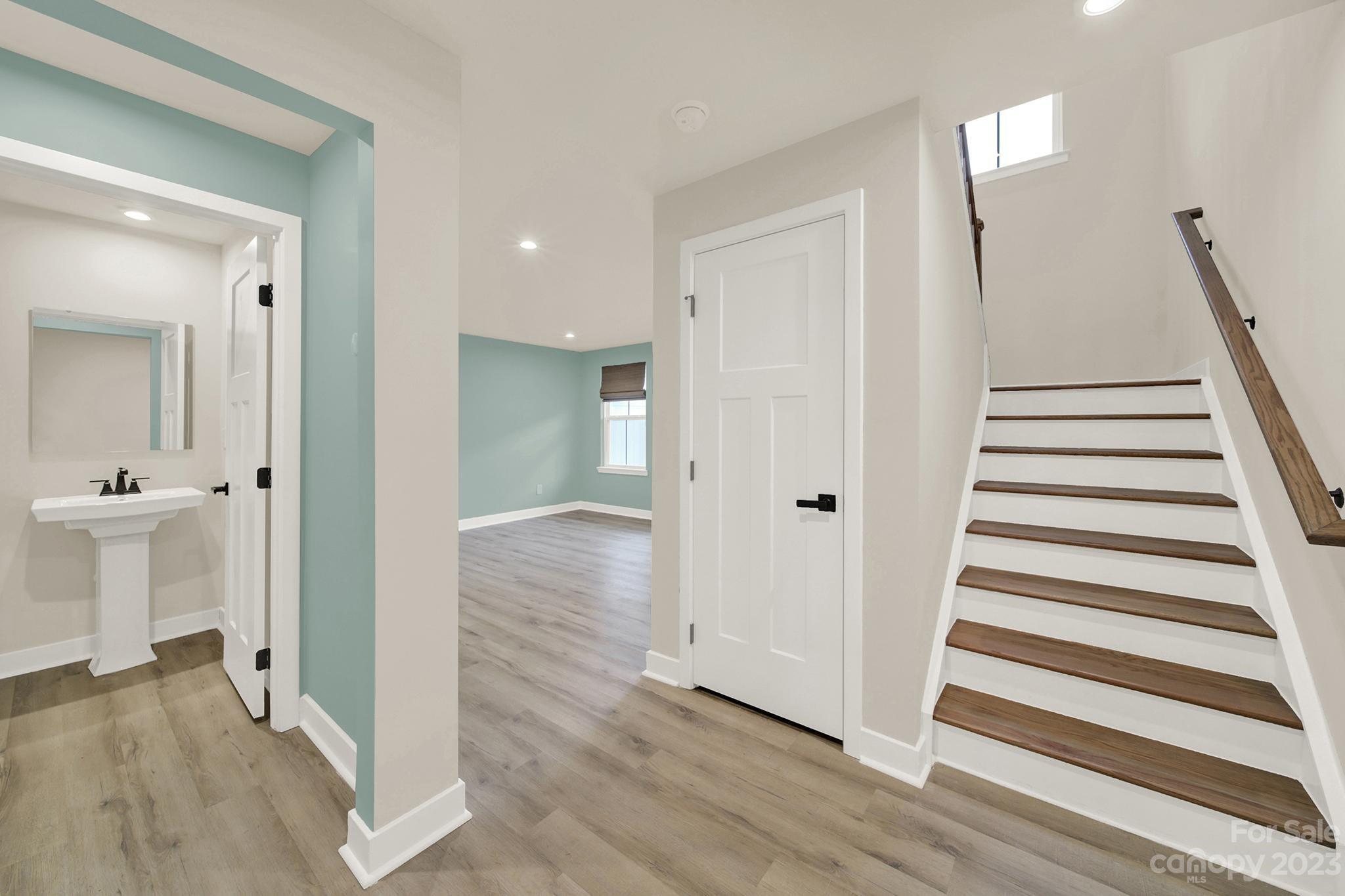 930 Portrush Lane Tega Cay, SC 29708 - Photo 9 of 40 a view of a hallway with wooden floor and entryway