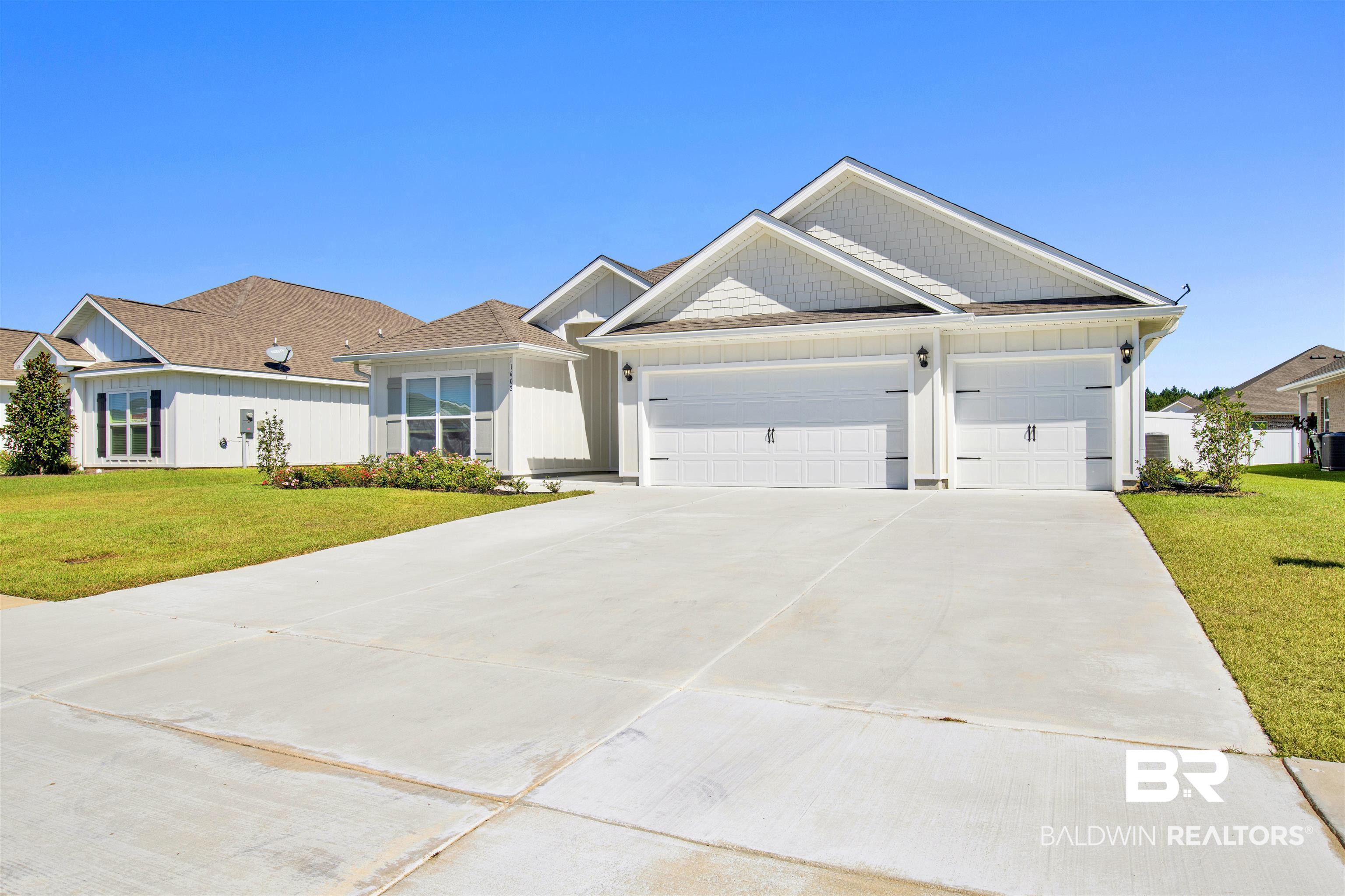 11602 Genuine Risk Circle Daphne, AL 36526 - Photo 2 of 30 View of front of property featuring a front lawn, concrete driveway, and an attached garage