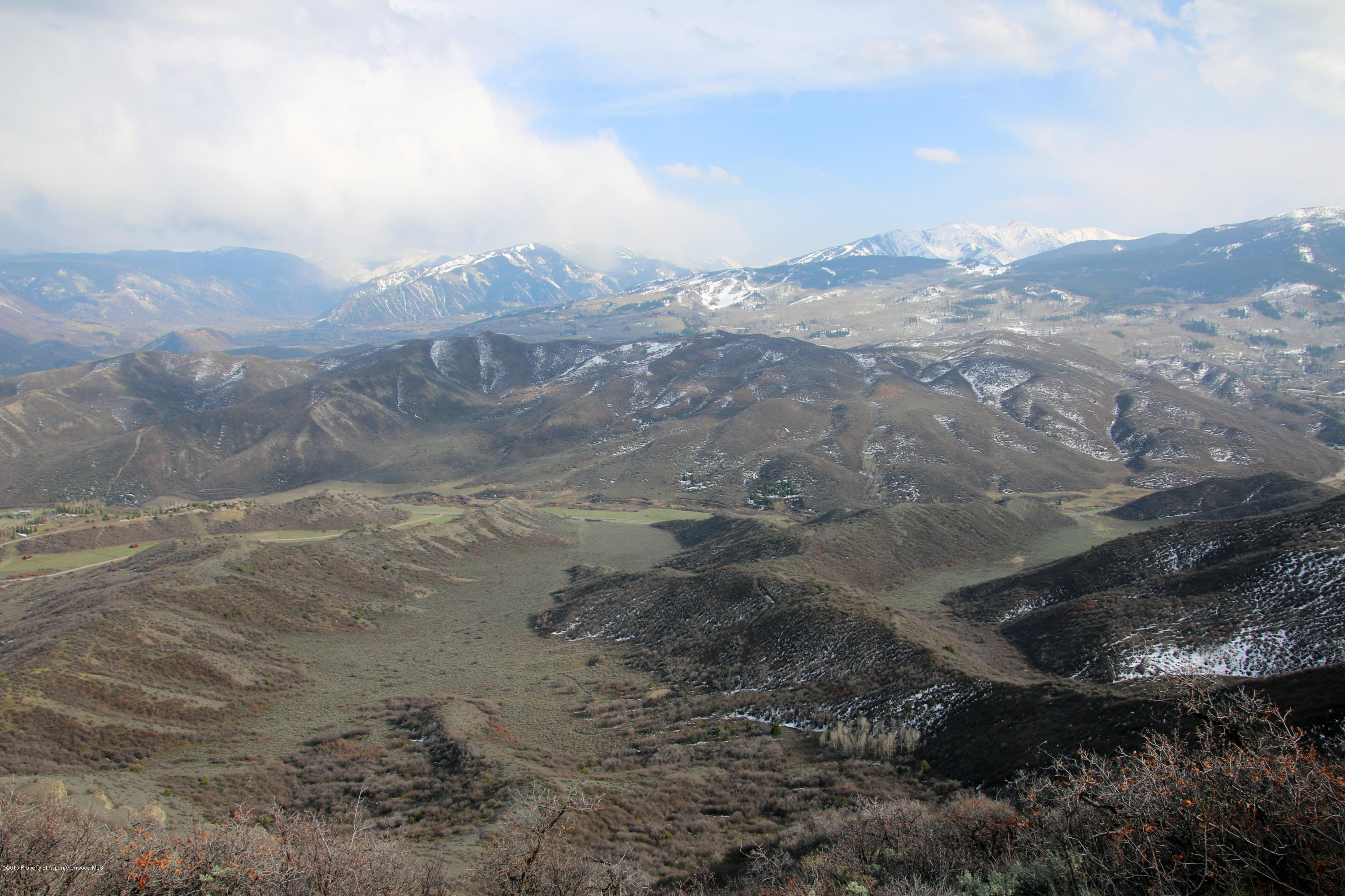 4000 Juniper Hill Road Aspen, CO 81611 - Photo 17 of 63 a view of a dry yard with mountains in the background