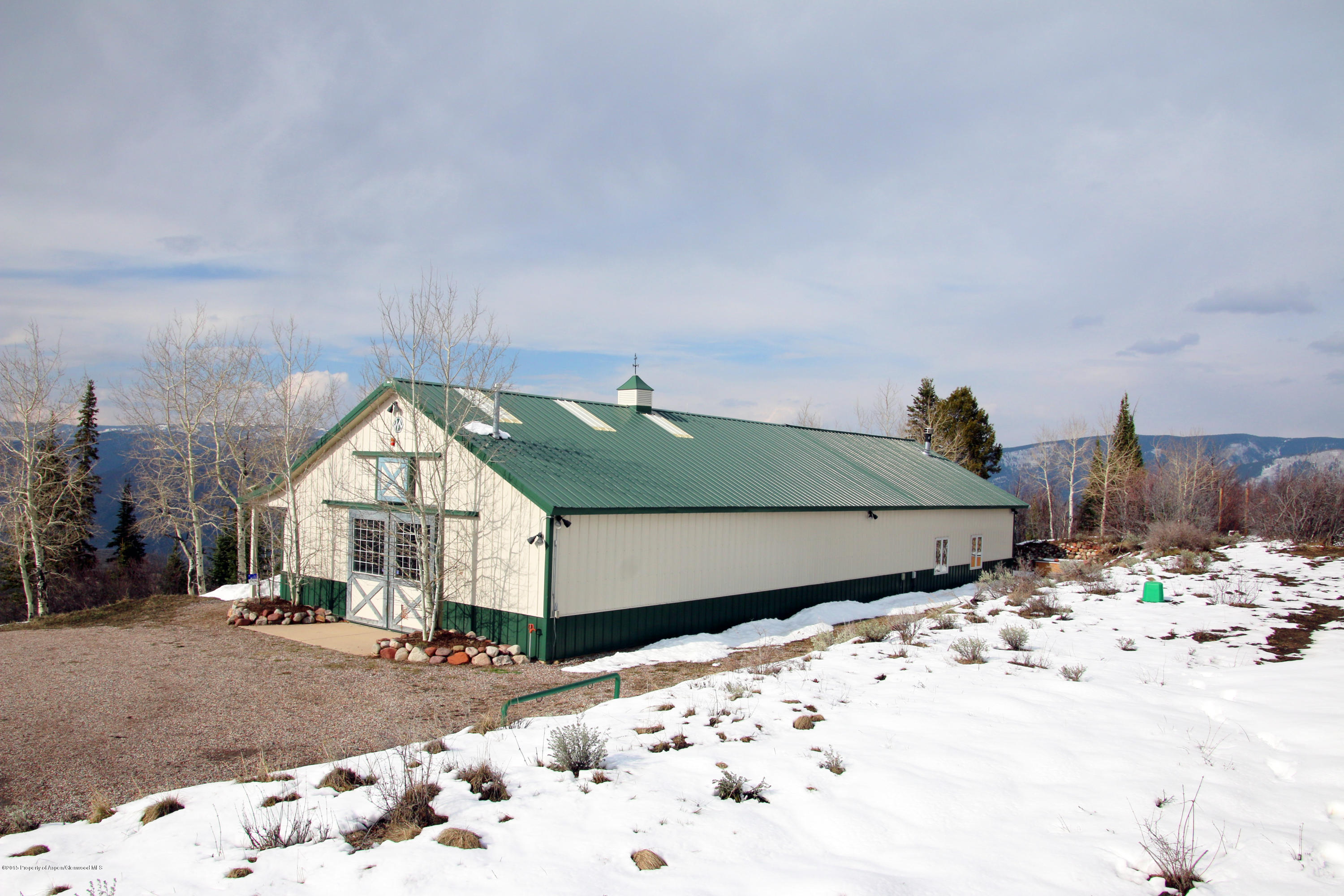 4000 Juniper Hill Road Aspen, CO 81611 - Photo 32 of 63 a wooden bench sitting in front of a house