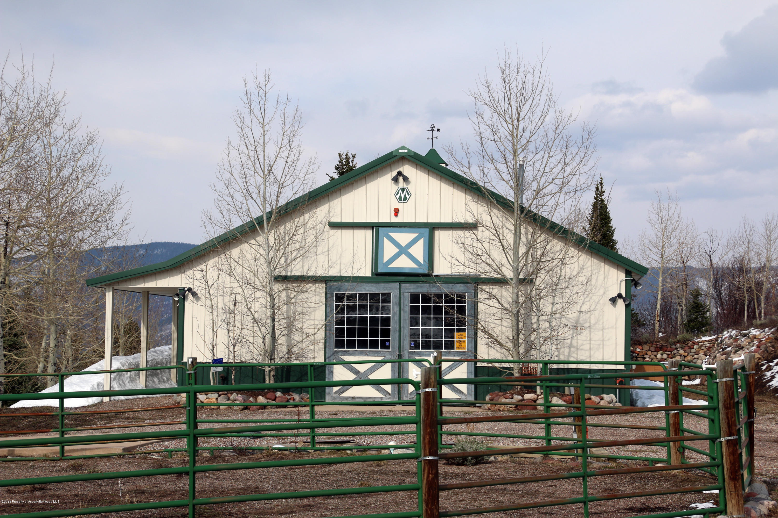 4000 Juniper Hill Road Aspen, CO 81611 - Photo 38 of 63 a view of a house with large windows and a table