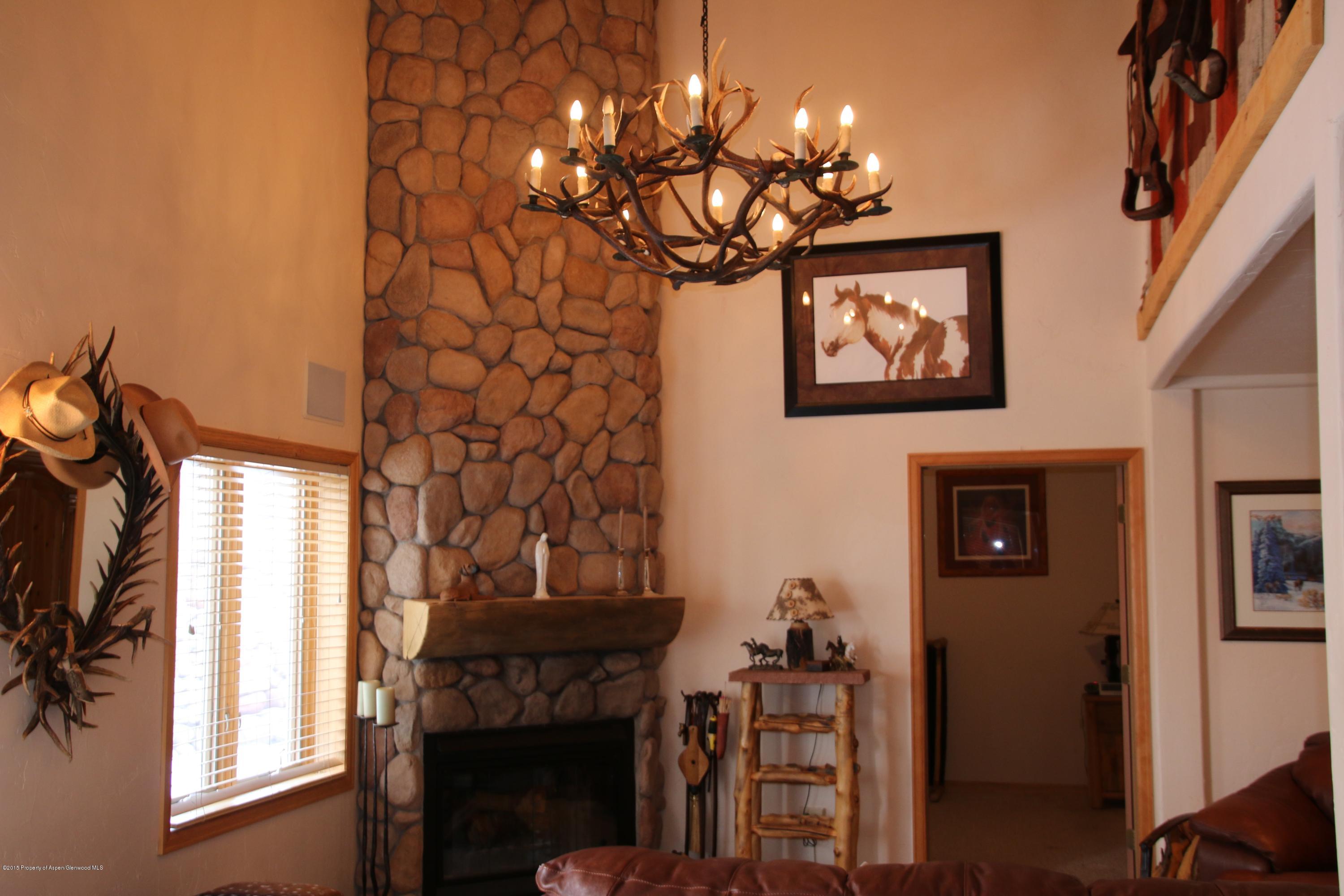 4000 Juniper Hill Road Aspen, CO 81611 - Photo 51 of 63 a vase of flowers sitting on a table in front of a window