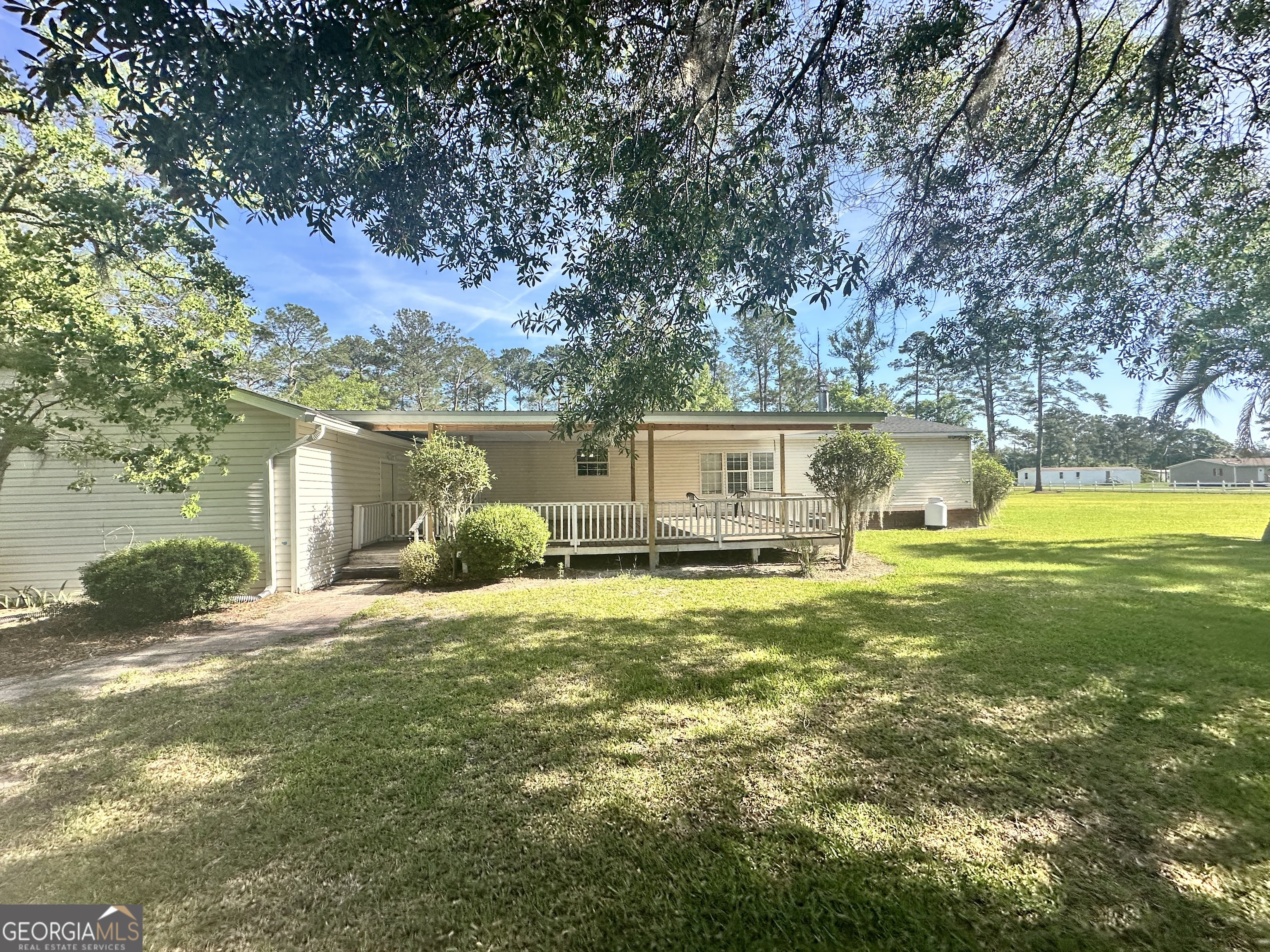 6498 Central Avenue Waycross, GA 31503 - Photo 18 of 20 a view of a house with pool and a yard