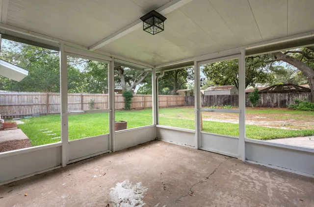 a view of a backyard with porch and furniture