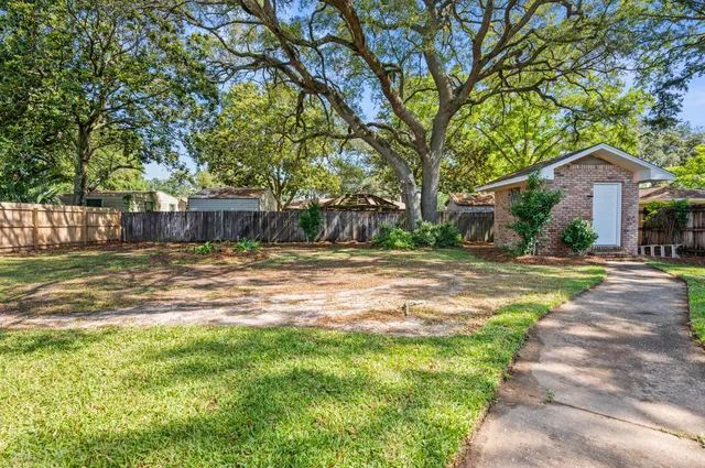 a house view with swimming pool in front of it