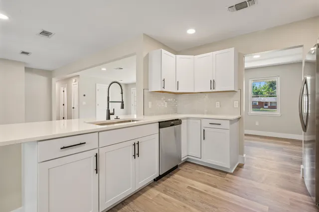 a view of cabinets a sink and dishwasher in a kitchen