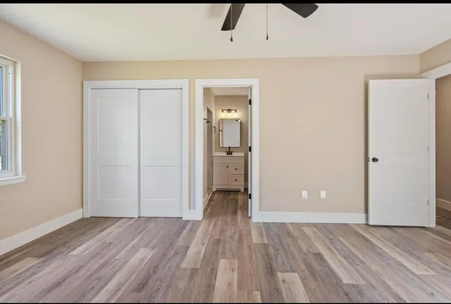 wooden floor in an empty room with a window