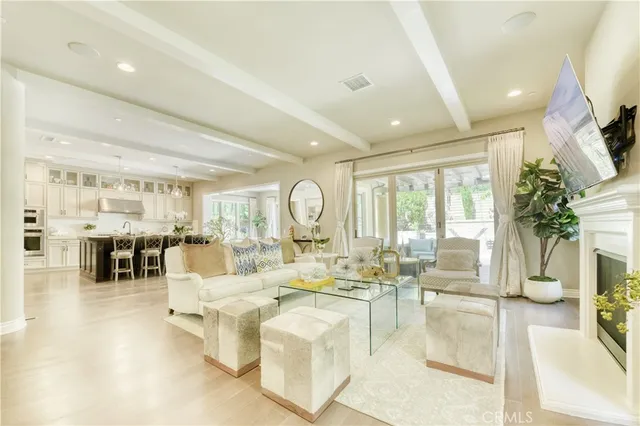 a living room with fireplace furniture and a large window