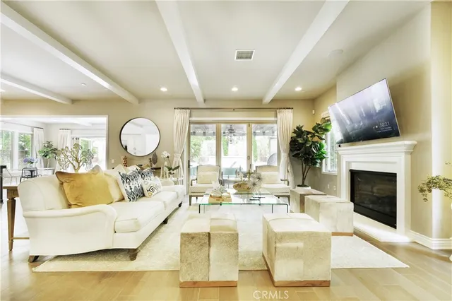 a living room with fireplace furniture and a large window