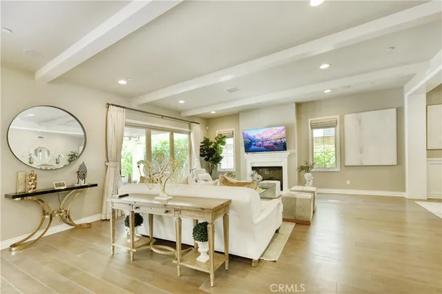 a living room with fireplace furniture and a large window