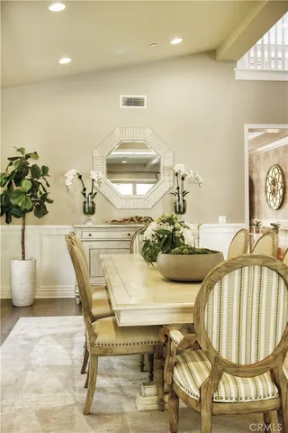 a dining room with furniture and wooden floor