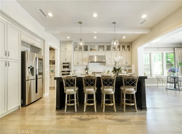 a large kitchen with a table and chairs
