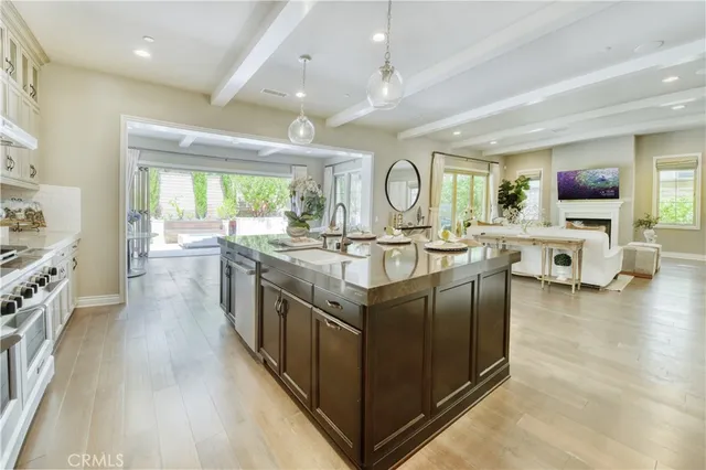 a kitchen with stainless steel appliances granite countertop a stove and a large window