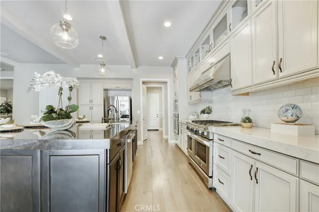 a kitchen with cabinets and stainless steel appliances