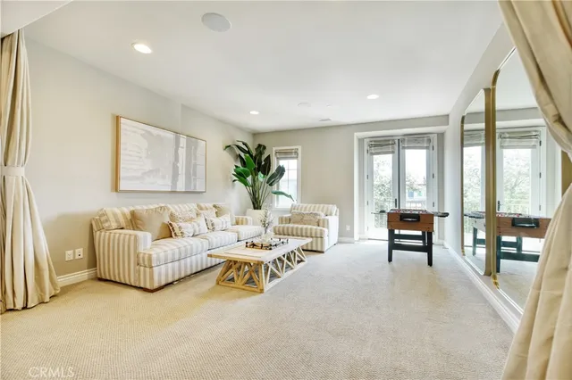a living room with furniture and large windows