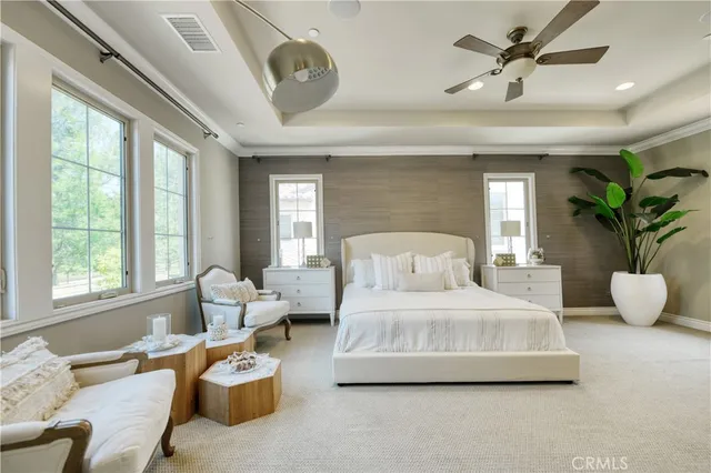 a bedroom with a bed and ceiling fan