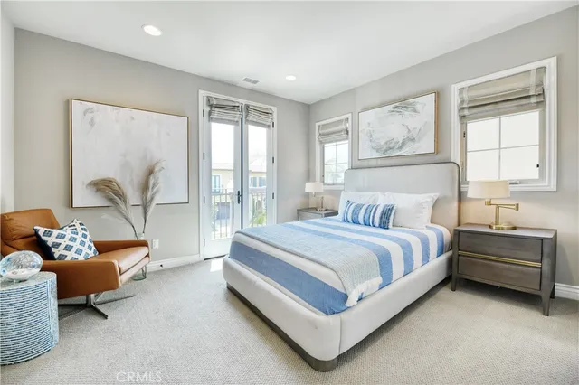 a spacious bedroom with a bed and a couch