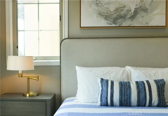 a bed sitting in a bedroom next to a window