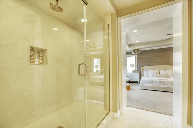 a bathroom with a granite countertop sink mirror and a shower