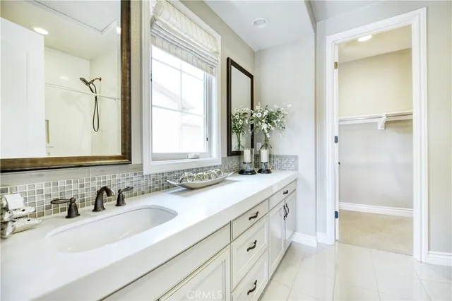 a bathroom with a tub sink and mirror
