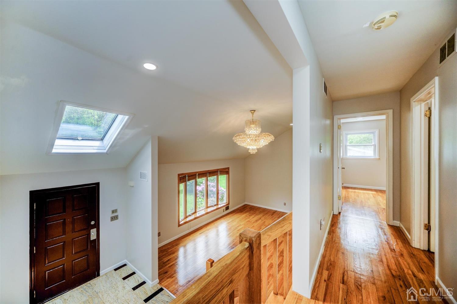 19 Greenwich Road Edison, NJ 08820 - Photo 15 of 39 a view of hallway with furniture and wooden floor