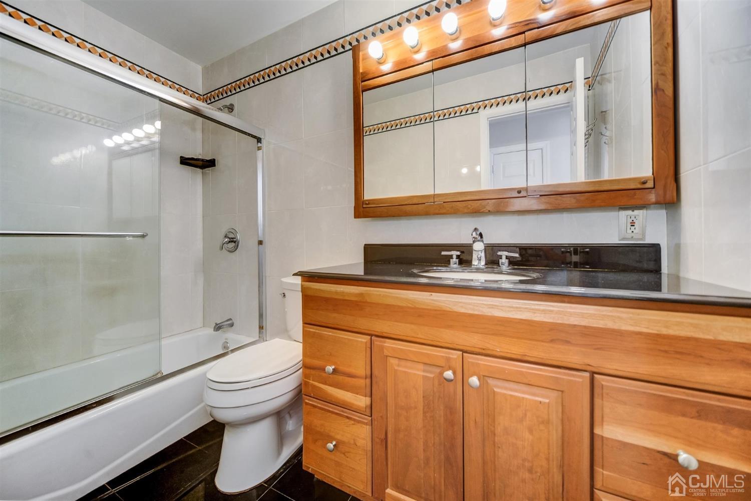 19 Greenwich Road Edison, NJ 08820 - Photo 17 of 39 a bathroom with a granite countertop sink toilet and shower