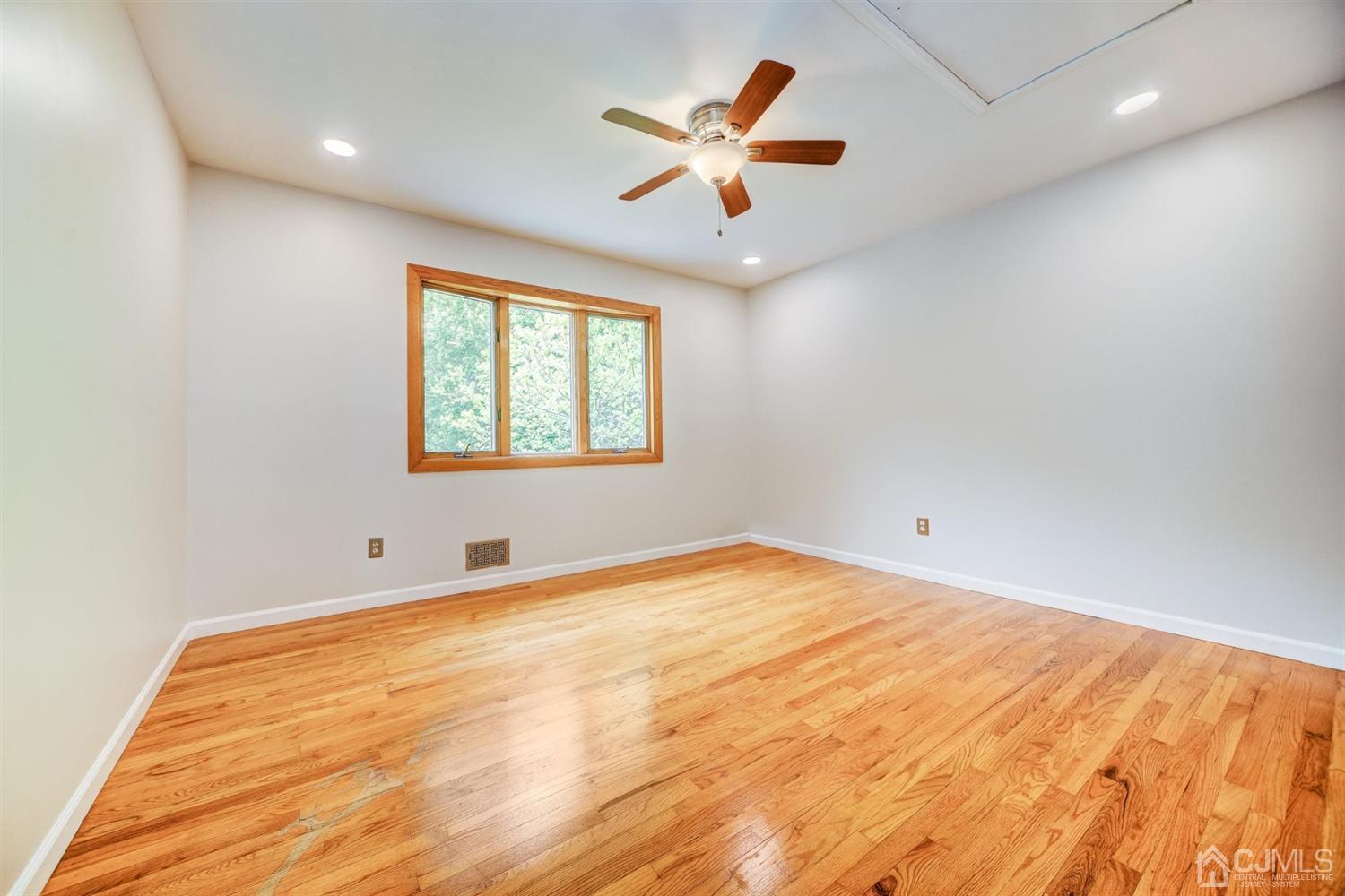 19 Greenwich Road Edison, NJ 08820 - Photo 19 of 39 an empty room with a window and a ceiling fan