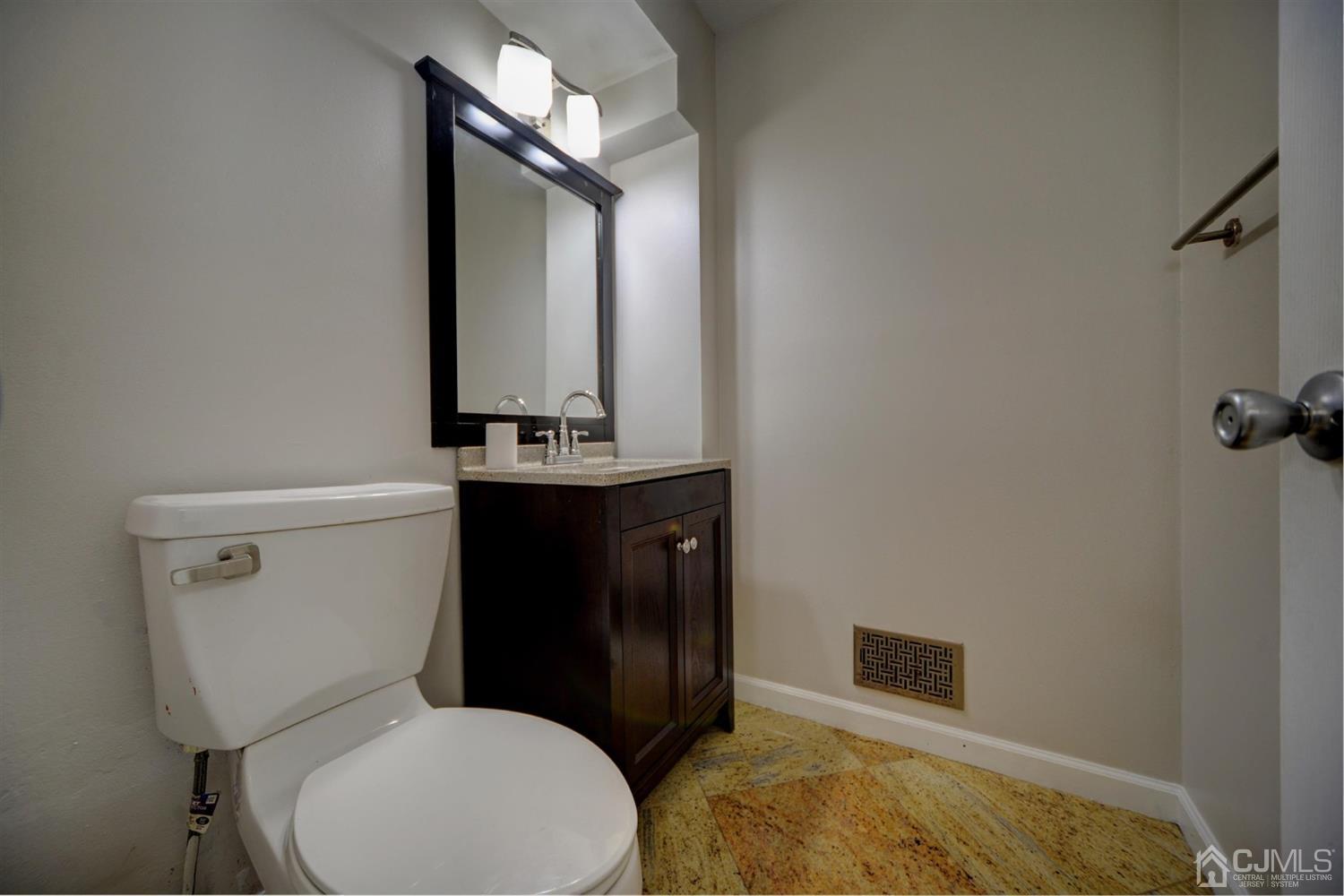 19 Greenwich Road Edison, NJ 08820 - Photo 20 of 39 a bathroom with a toilet sink and mirror