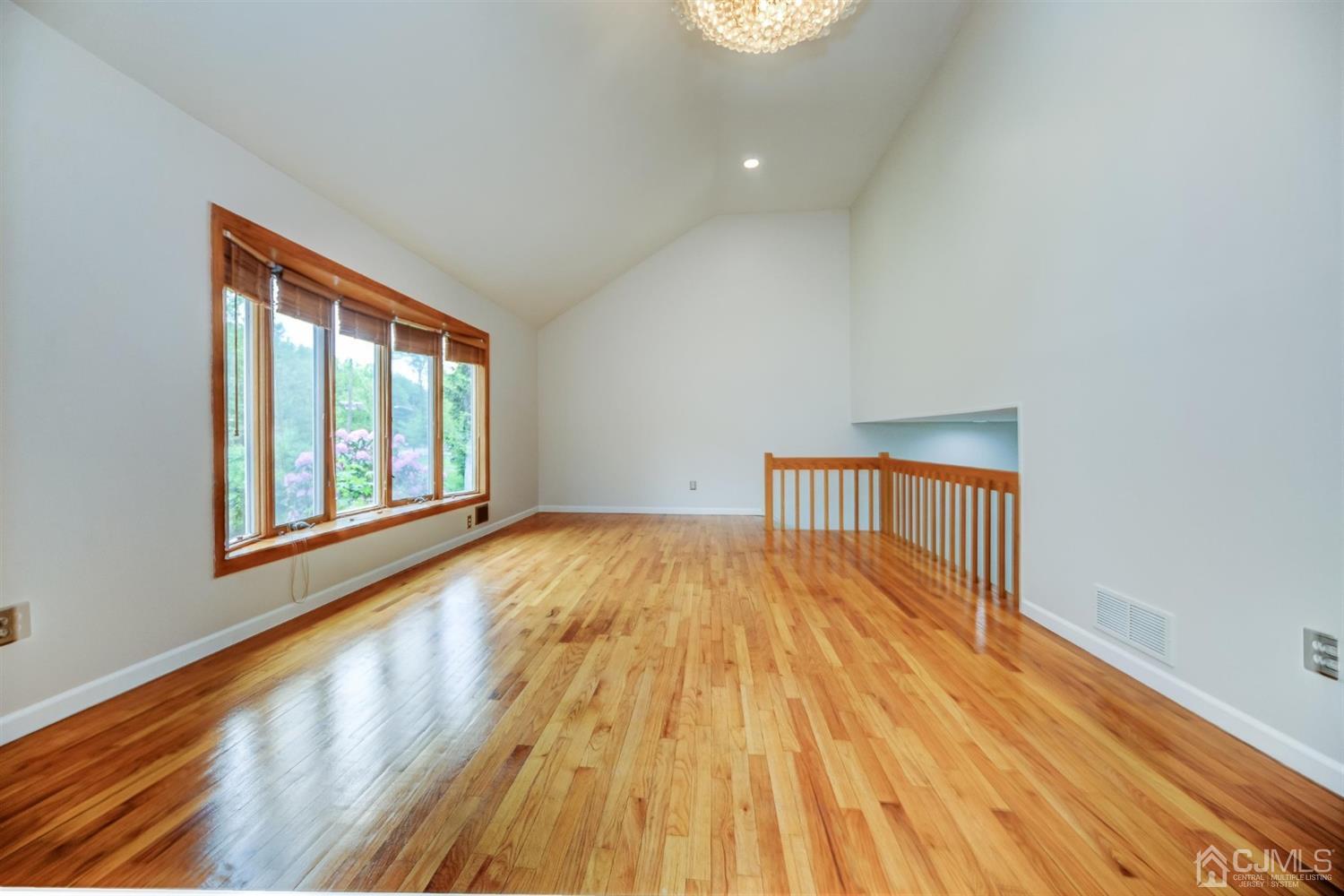 19 Greenwich Road Edison, NJ 08820 - Photo 5 of 39 a view of an empty room with wooden floor and a window