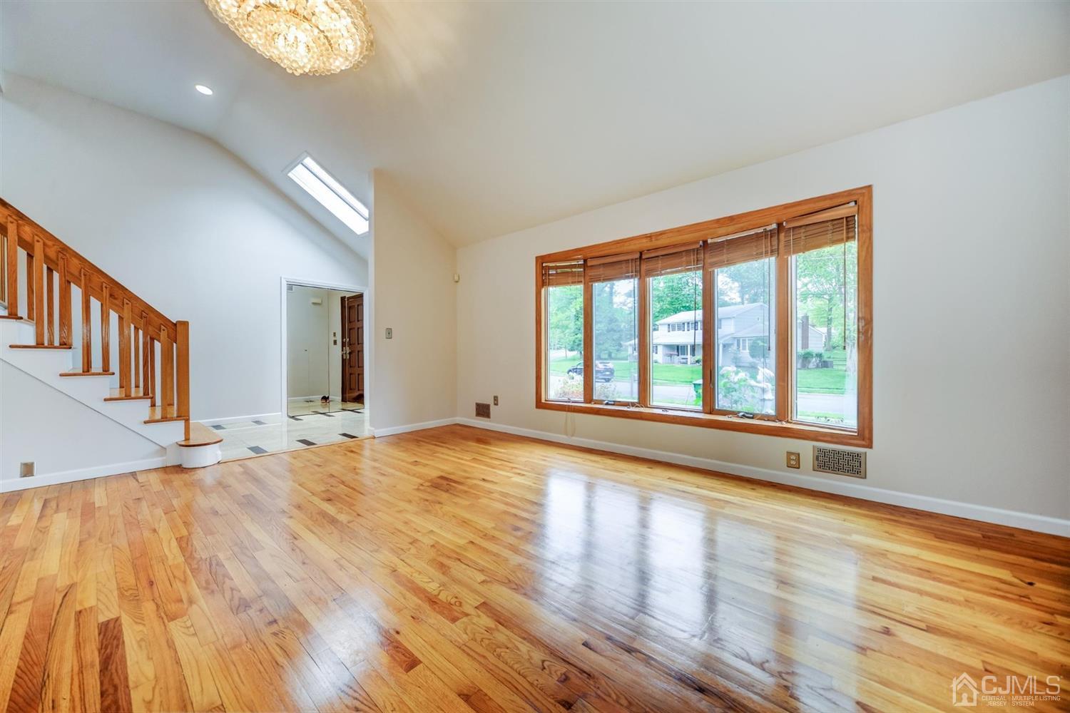 19 Greenwich Road Edison, NJ 08820 - Photo 6 of 39 a view of an empty room with wooden floor and a window