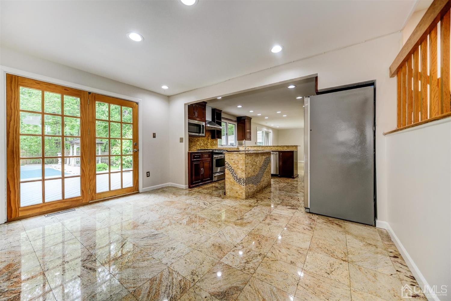 19 Greenwich Road Edison, NJ 08820 - Photo 8 of 39 a large white room with stainless steel appliances kitchen island granite countertop a refrigerator and a sink