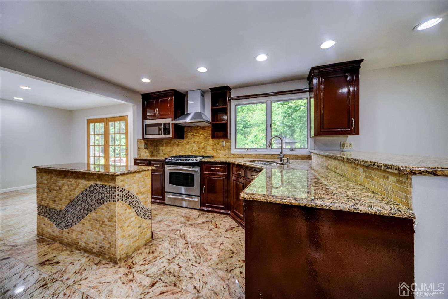 19 Greenwich Road Edison, NJ 08820 - Photo 10 of 39 a kitchen with stainless steel appliances granite countertop a stove sink and cabinets