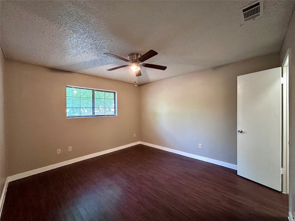 1500 No Mor Cove, Unit B Austin, TX 78758 - Photo 11 of 17 an empty room with wooden floor and windows