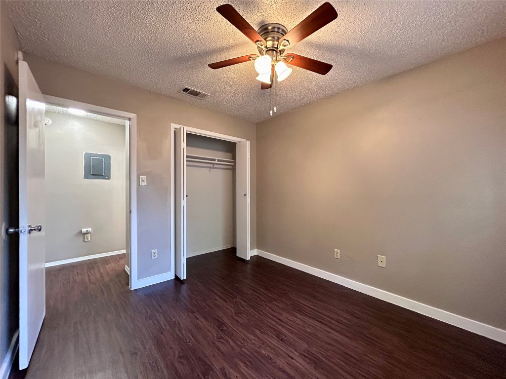 1500 No Mor Cove, Unit B Austin, TX 78758 - Photo 14 of 17 an empty room with wooden floor and a ceiling fan