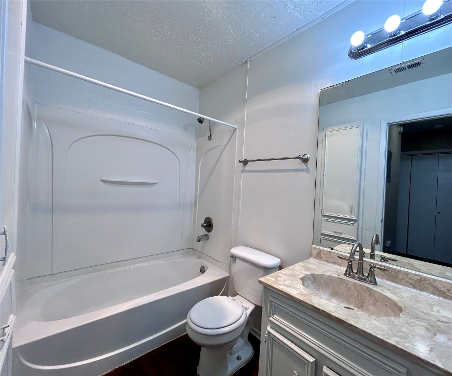 1500 No Mor Cove, Unit B Austin, TX 78758 - Photo 15 of 17 a bathroom with a granite countertop toilet sink and mirror