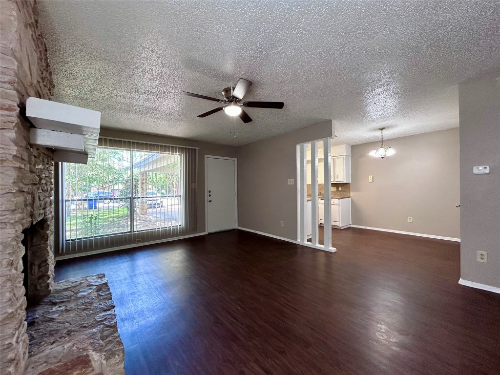 1500 No Mor Cove, Unit B Austin, TX 78758 - Photo 3 of 17 a view of an empty room with a window and wooden floor