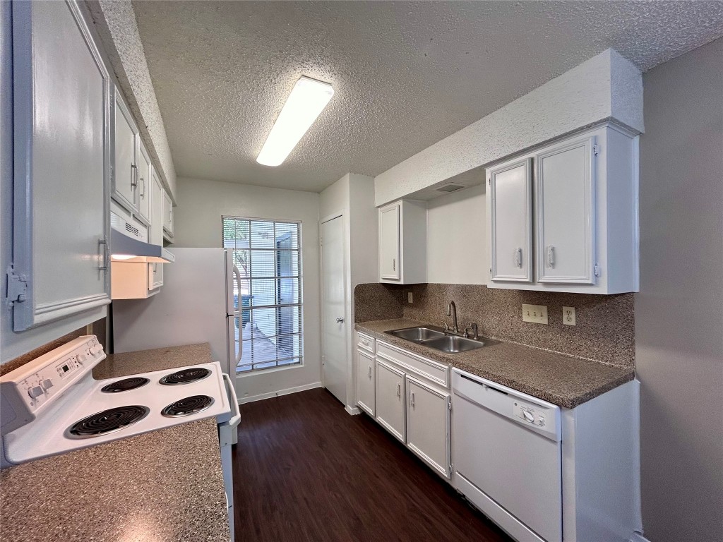 1500 No Mor Cove, Unit B Austin, TX 78758 - Photo 7 of 17 a kitchen with stainless steel appliances granite countertop a stove a sink and a microwave