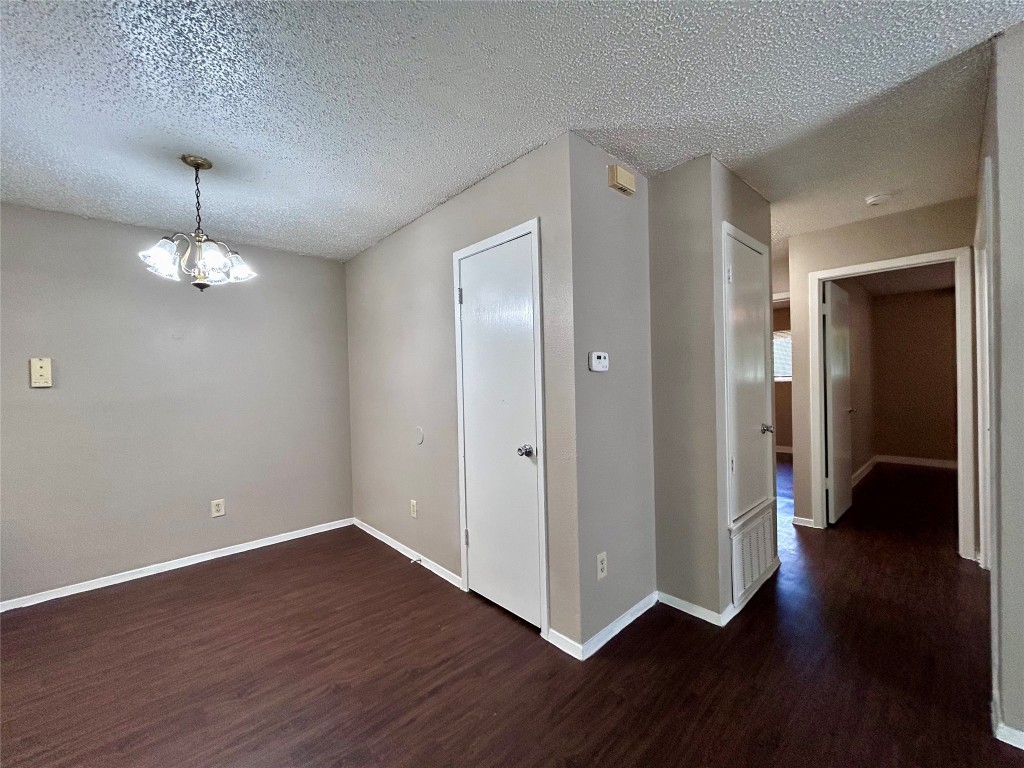 1500 No Mor Cove, Unit B Austin, TX 78758 - Photo 9 of 17 a view of a hallway with wooden floor and chandelier