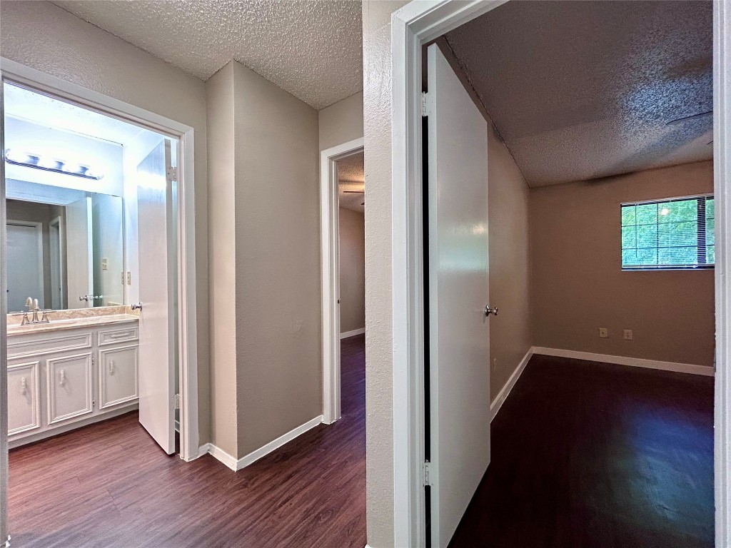1500 No Mor Cove, Unit B Austin, TX 78758 - Photo 10 of 17 a view of a hallway with wooden floor and a bathroom