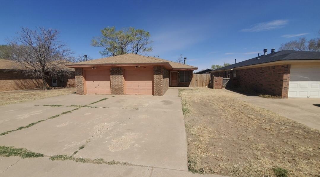 6110 38th Street, Unit B Lubbock, TX 79407 - Photo 1 of 1 a wooden bench sitting in middle of a snow